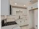 Modern kitchen features white cabinets, stainless appliances, and granite countertops at 6733 N 49Th Ave, Glendale, AZ 85301