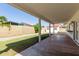 Open covered patio looks out onto fenced backyard, grass, garden box, and shed at 7214 W Columbine Dr, Peoria, AZ 85381