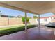 Covered patio overlooks fenced backyard with grass, garden box and storage shed at 7214 W Columbine Dr, Peoria, AZ 85381