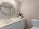 Bathroom featuring vanity with oval mirror, stylish plant, and a toilet at 7214 W Columbine Dr, Peoria, AZ 85381