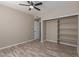 Neutral bedroom features a ceiling fan, modern floors, and spacious closet with shelving at 7214 W Columbine Dr, Peoria, AZ 85381