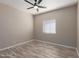 Bedroom featuring modern flooring, ceiling fan, and a window for natural light at 7214 W Columbine Dr, Peoria, AZ 85381
