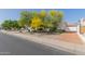 Single-story home featuring desert landscaping, mature trees, and a well-maintained front yard at 7214 W Columbine Dr, Peoria, AZ 85381
