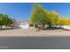 Charming single-story home featuring a well-manicured front yard with mature desert landscaping and a spacious driveway at 7214 W Columbine Dr, Peoria, AZ 85381