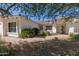 Single-story house featuring lush desert landscaping, ample natural light, and a well-maintained exterior at 7214 W Columbine Dr, Peoria, AZ 85381