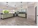 Charming kitchen with green cabinetry, granite counters, and stainless steel appliances at 7214 W Columbine Dr, Peoria, AZ 85381