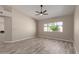 Inviting living area with modern ceiling fan, wood floors and bright natural light at 7214 W Columbine Dr, Peoria, AZ 85381