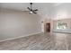 Spacious living room with wood floors, stylish lighting fixtures, and an open layout at 7214 W Columbine Dr, Peoria, AZ 85381