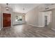 Open living space with wood floors, built-in shelving and contemporary light fixtures at 7214 W Columbine Dr, Peoria, AZ 85381