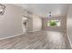Bright living room featuring wood floors, neutral walls, and a modern ceiling fan at 7214 W Columbine Dr, Peoria, AZ 85381