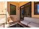 Cozy balcony with a modern patio set, exterior lighting, and view of the interior at 7300 E Earll Dr # 1022, Scottsdale, AZ 85251