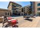 A tranquil outdoor pool area featuring lounge chairs, tables, and a modern stone feature for relaxation at 7300 E Earll Dr # 1022, Scottsdale, AZ 85251