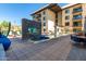 An inviting pool area including a spa with stone accents and ample lounging space, set against a modern building at 7300 E Earll Dr # 1022, Scottsdale, AZ 85251