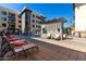 Beautiful outdoor pool area with lounge chairs and modern architectural details under a bright blue sky at 7300 E Earll Dr # 1022, Scottsdale, AZ 85251
