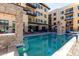 Capture of a luxurious outdoor pool with modern design, stone features, and stylish patio furniture for relaxing by the water at 7300 E Earll Dr # 1022, Scottsdale, AZ 85251