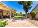 Expansive backyard with lush lawn, brick patio, covered patio and mature trees, perfect for outdoor living at 7515 W Sweetwater Ave, Peoria, AZ 85381