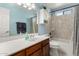 Well-lit bathroom features a single sink vanity, large mirror and a bathtub with shower at 7515 W Sweetwater Ave, Peoria, AZ 85381