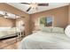 Bedroom with ceiling fan, hardwood floors, and a mirrored closet at 7515 W Sweetwater Ave, Peoria, AZ 85381