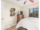 Bright bedroom with hardwood floors, ceiling fan, and dresser with TV at 7515 W Sweetwater Ave, Peoria, AZ 85381