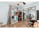 Bedroom featuring hardwood floors, a closet with mirrors and a ceiling fan at 7515 W Sweetwater Ave, Peoria, AZ 85381