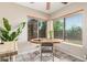 Bright breakfast nook featuring two windows and a wood table. The room has neutral walls and tiled floors at 7515 W Sweetwater Ave, Peoria, AZ 85381