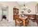 Traditional dining room with wood furniture and decorative accents. The room has neutral paint colors and tiled floors at 7515 W Sweetwater Ave, Peoria, AZ 85381