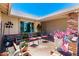 Cozy front patio with brick accents, seating area, potted plants, and charming outdoor decor at 7515 W Sweetwater Ave, Peoria, AZ 85381
