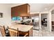 Galley-style kitchen featuring stainless steel appliances and an eat-in bar. A window offers natural light at 7515 W Sweetwater Ave, Peoria, AZ 85381
