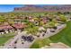 Aerial view of a home with a red tile roof surrounded by desert landscaping and a golf course at 7780 E Golden Eagle Cir, Gold Canyon, AZ 85118