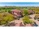 Aerial view of a home showcasing red tile roof, desert landscaping, and three-car garage at 7780 E Golden Eagle Cir, Gold Canyon, AZ 85118