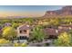 Stunning aerial view of desert community homes with red tile roofs and mountain views at sunset at 7780 E Golden Eagle Cir, Gold Canyon, AZ 85118