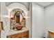 Charming powder room features decorative tile wall, copper bowl sink, and arched alcove at 7780 E Golden Eagle Cir, Gold Canyon, AZ 85118
