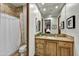 Bathroom features a wooden vanity, marble countertop, and a shower with tile surround at 7780 E Golden Eagle Cir, Gold Canyon, AZ 85118