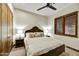 Bedroom with dark wood accents, plantation shutters, neutral color palette, and carpeted floors at 7780 E Golden Eagle Cir, Gold Canyon, AZ 85118
