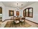 Dining room with chandelier, wooden furniture, and a large window at 7780 E Golden Eagle Cir, Gold Canyon, AZ 85118