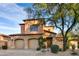 Charming two-story home with a stone-accented facade, two-car garage, and mature landscaping at 7780 E Golden Eagle Cir, Gold Canyon, AZ 85118