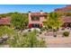 Aerial view of the back of a two-story house with a balcony overlooking a desert landscape at 7780 E Golden Eagle Cir, Gold Canyon, AZ 85118