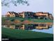 View of the spacious Superstition Mountain Golf and Country Club Clubhouse with reflected image in pond at 7780 E Golden Eagle Cir, Gold Canyon, AZ 85118