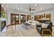 Bright living room with fireplace, tile floors, and access to the backyard at 7780 E Golden Eagle Cir, Gold Canyon, AZ 85118