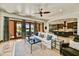 Inviting living room featuring tile floors, a ceiling fan, and seamless access to the outdoors through French doors at 7780 E Golden Eagle Cir, Gold Canyon, AZ 85118