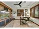 Well-lit home office with built-in shelving, desk, and large window with wooden shutters at 7780 E Golden Eagle Cir, Gold Canyon, AZ 85118
