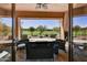 Covered patio overlooking a lush golf course, furnished for outdoor relaxation and entertainment at 7780 E Golden Eagle Cir, Gold Canyon, AZ 85118
