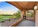 Covered patio overlooking the golf course and desert landscape with an outdoor fireplace at 7780 E Golden Eagle Cir, Gold Canyon, AZ 85118