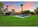 Serene backyard with lush lawn, sparkling pool, and ample space for outdoor enjoyment at 7813 N 17Th Dr, Phoenix, AZ 85021