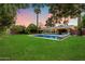 A stunning backyard features a pool, patio and beautiful sunset at 7813 N 17Th Dr, Phoenix, AZ 85021