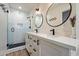This bathroom features a double vanity and walk-in shower with glass doors at 7813 N 17Th Dr, Phoenix, AZ 85021