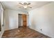 This bedroom features wood floors, a ceiling fan and a walk-in closet at 7813 N 17Th Dr, Phoenix, AZ 85021