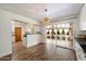 Dining area showcasing modern light fixture, white cabinets, and access to the back patio at 7813 N 17Th Dr, Phoenix, AZ 85021