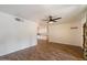 Spacious living area with wood-look floors, ceiling fan, and direct access to kitchen at 7813 N 17Th Dr, Phoenix, AZ 85021