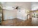 Open living room features wood-look floors, ceiling fan, and an adjoining kitchen at 7813 N 17Th Dr, Phoenix, AZ 85021